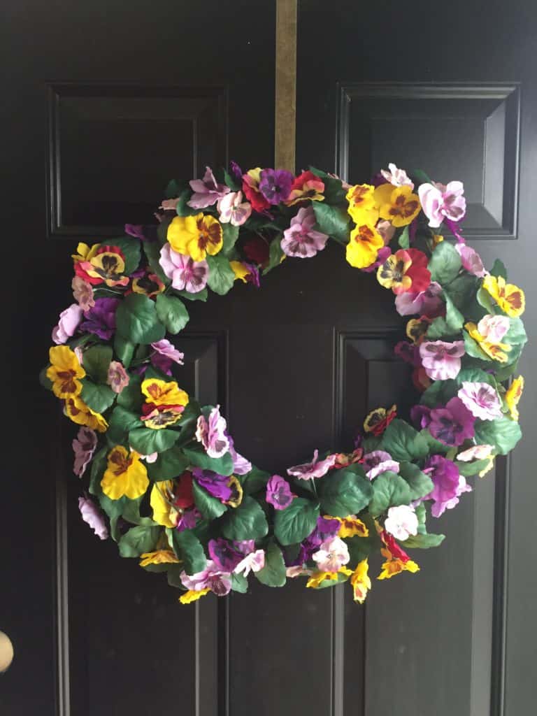 Use floral garland and a wire wreath frame for create a colorful spring wreath for your front door.