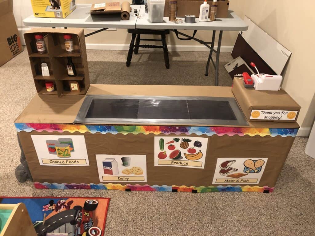 It is really easy and inexpensive to build a grocery store checkout counter for toddlers and preschoolers. They can learn so many skills from engaging in grocery store dramatic play. Learn how to set up grocery store dramatic play for your littles ones.